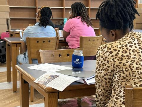 A woman reading a manual.